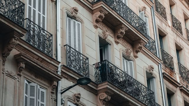 a tall building with lots of windows and balconies