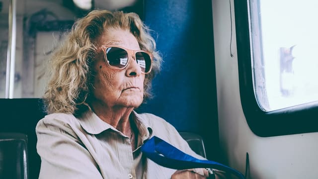 woman sitting on chair in front of window