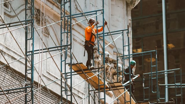 3 men climbing on ladder