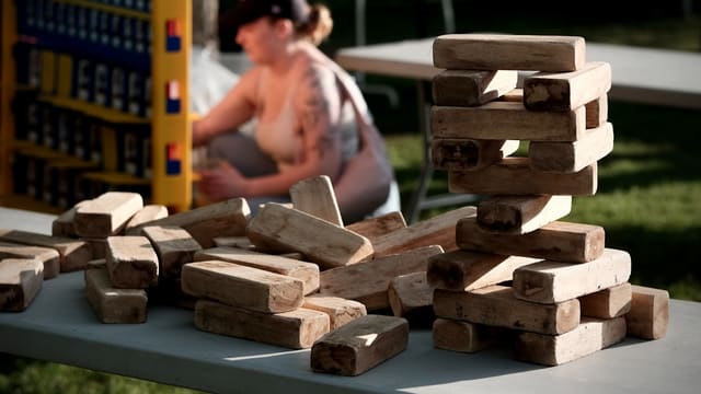 Stacked and scattered wooden blocks on a table outdoors.