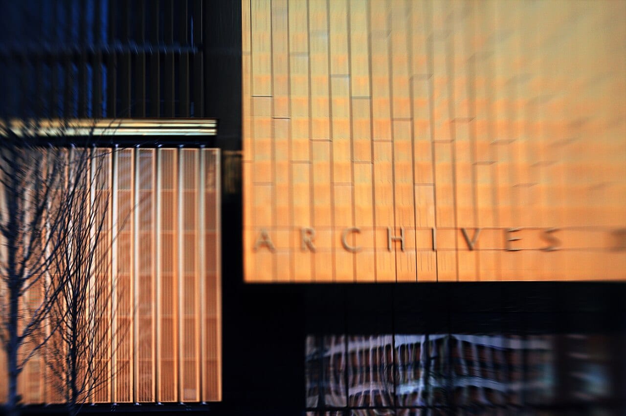 The Rhone departmental archives building. The Central France Télécom Lacassagne is reflected in the glass doors on the lower right.