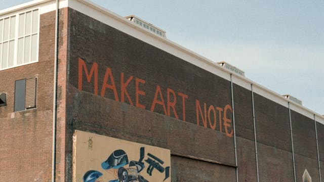 a brick building with graffiti on the side of it