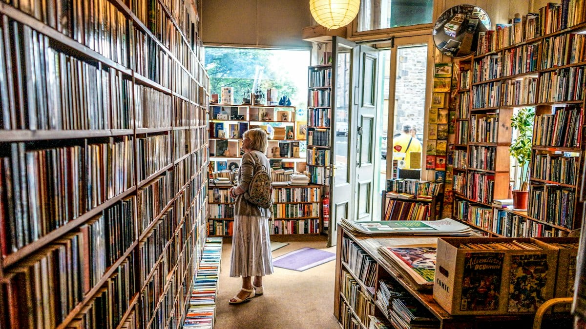 woman inside library looking at books