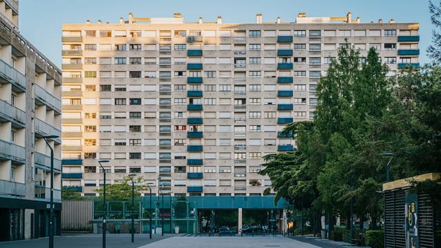 An empty street in front of a tall building