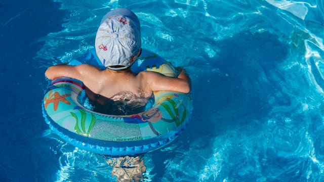 woman in blue swimming cap in pool
