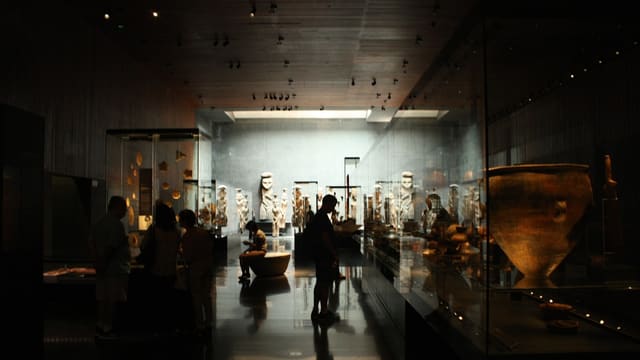 a group of people standing around a museum