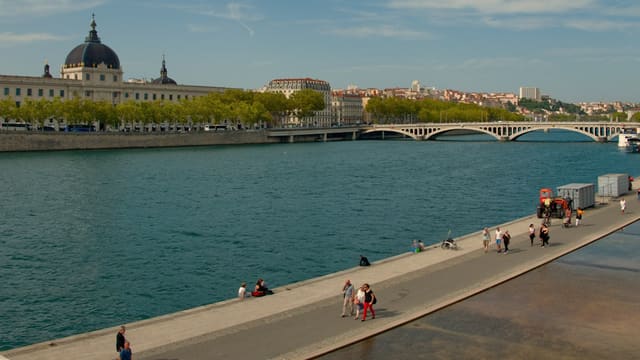 people walking beside river