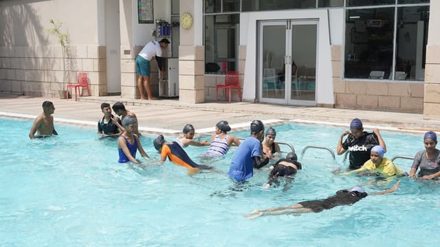 Children learning to swim in a pool