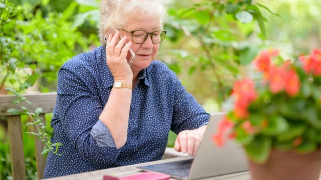 an old woman using a laptop