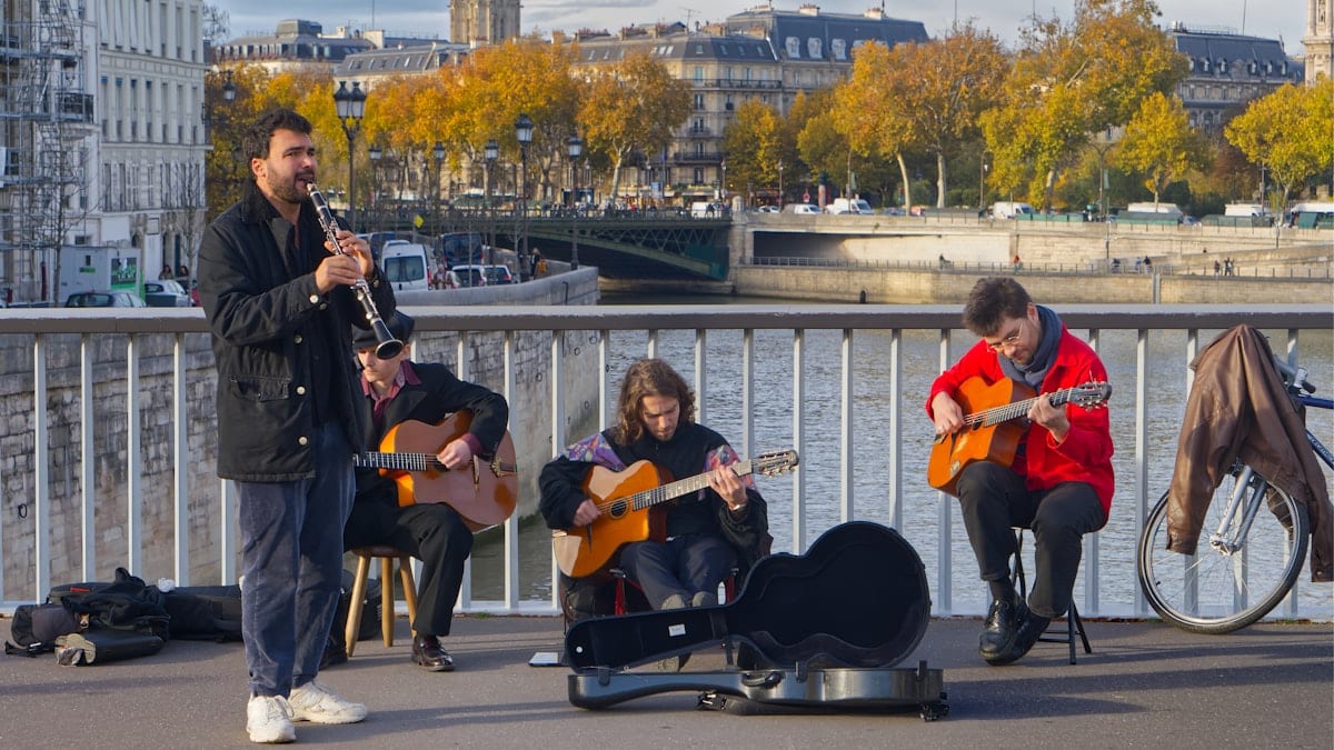 Musicians playing instruments on a bridge in paris