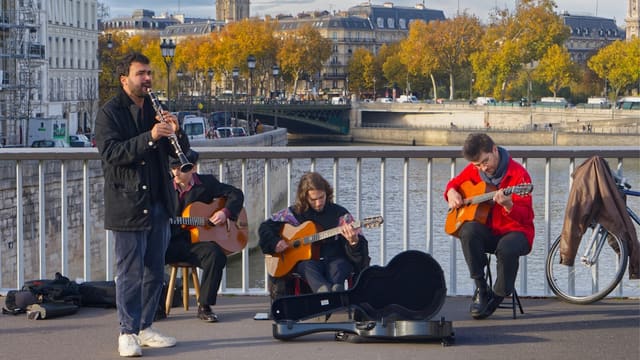 Musicians playing instruments on a bridge in paris