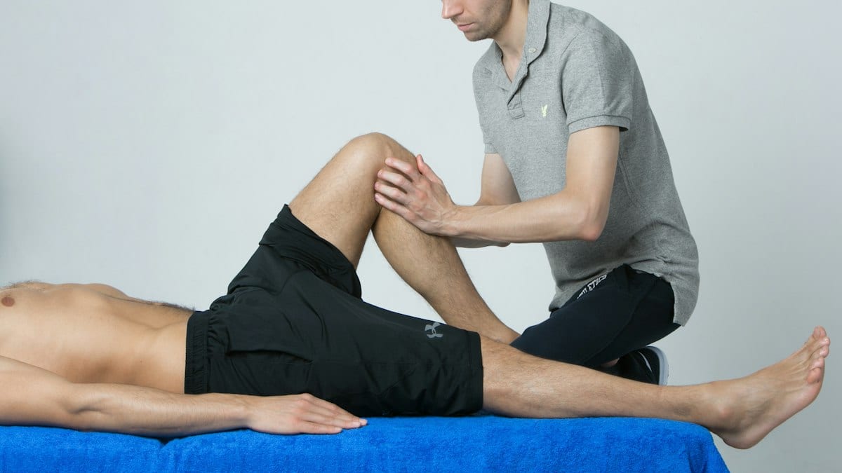 a man getting his leg examined by a doctor