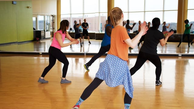 women dancing near mirror