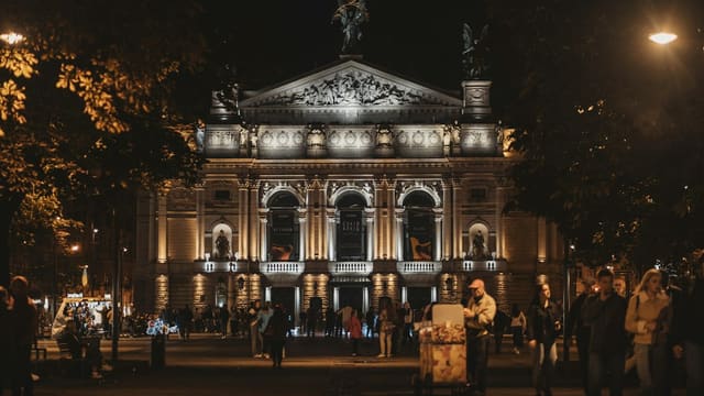 a group of people standing in front of a building