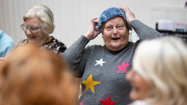 a woman covering her head with her hands