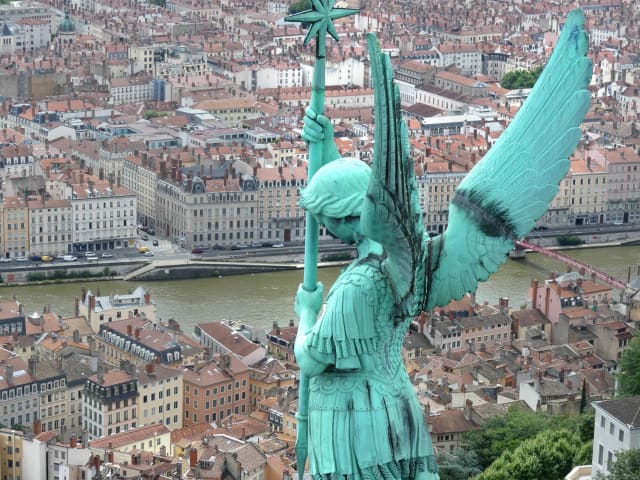 Overlooking Lyon from the Basilica Notre-Dame de Fourvière with angel statue in view.