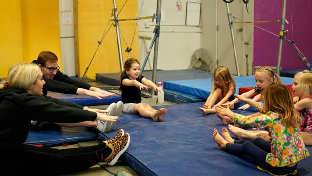 a group of people sitting on mats