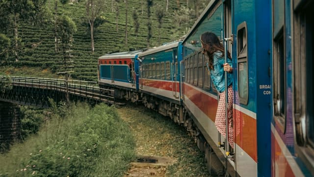 a woman standing on a train looking out the window