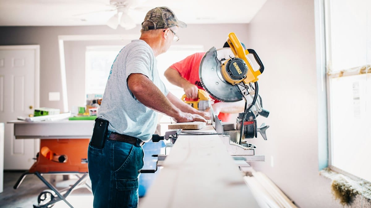 man standing infront of miter saw