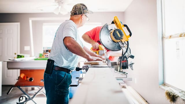 man standing infront of miter saw