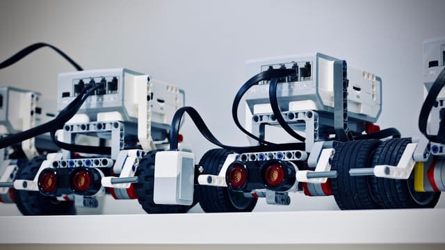 two white and black electronic device with wheels