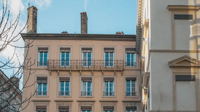 a building with balconies and a clock on the front of it