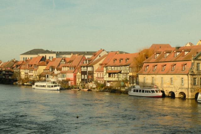 Scenic view of traditional buildings along Bamberg's riverfront showcasing historic charm and vibrant architecture.