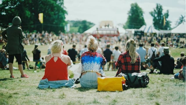 group of people on grass field under sunny day