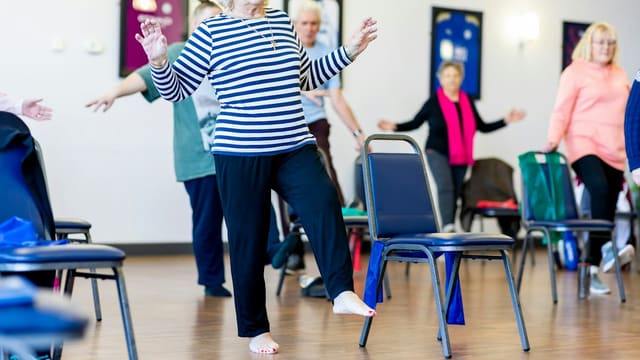 Groupe de femmes âgées dansant ensemble dans une salle