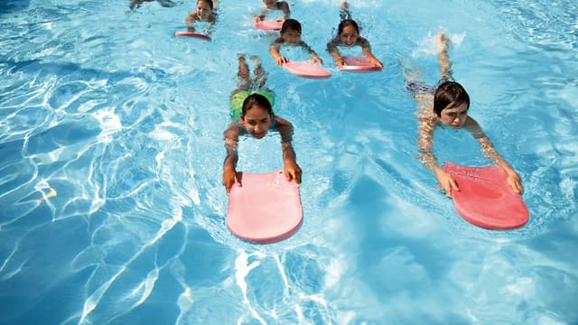 a group of kids in a pool