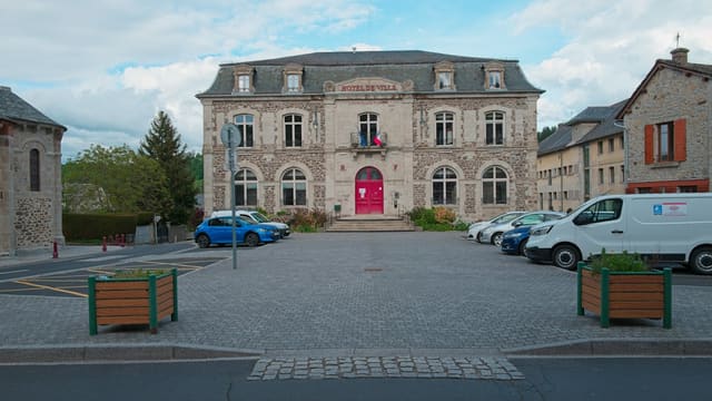 Town hall building with cars parked outside