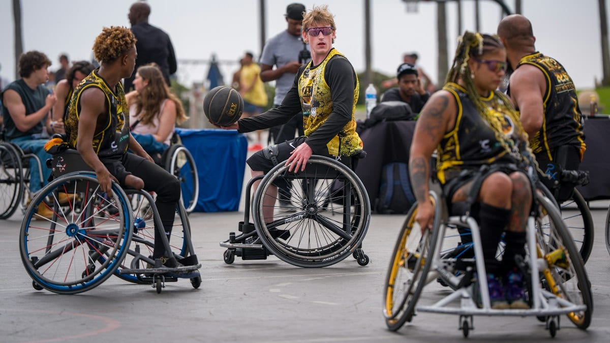 Wheelchair basketball players compete on an outdoor court