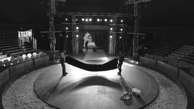 a black and white photo of a stage with a hammock