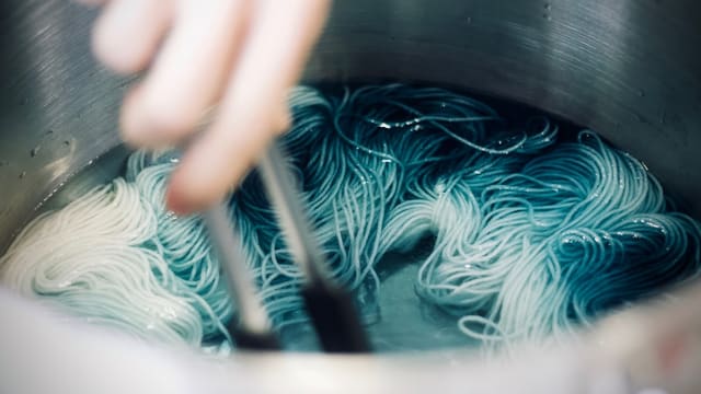 person cooking pasta