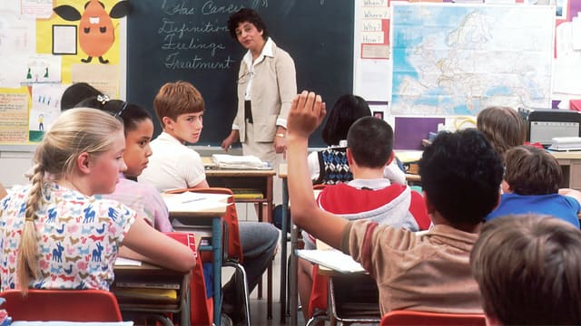 woman standing in front of children