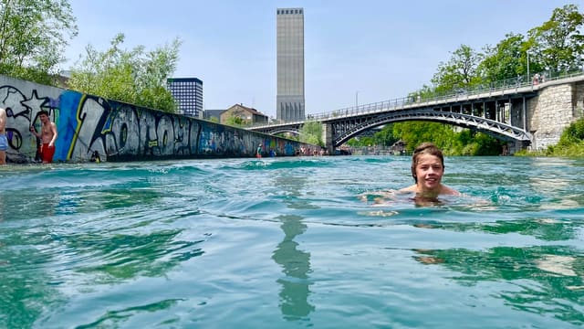 woman in swimming pool near bridge during daytime