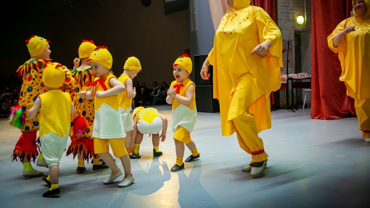 a person in a garment surrounded by children