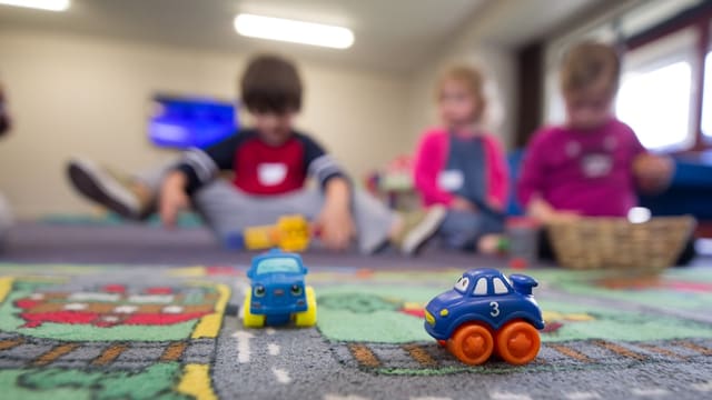 a group of children playing with toys on the floor