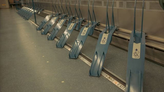 Empty bicycle racks inside a train car.