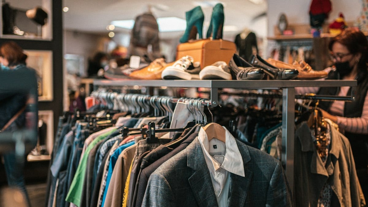 a rack of clothes and shoes in a store