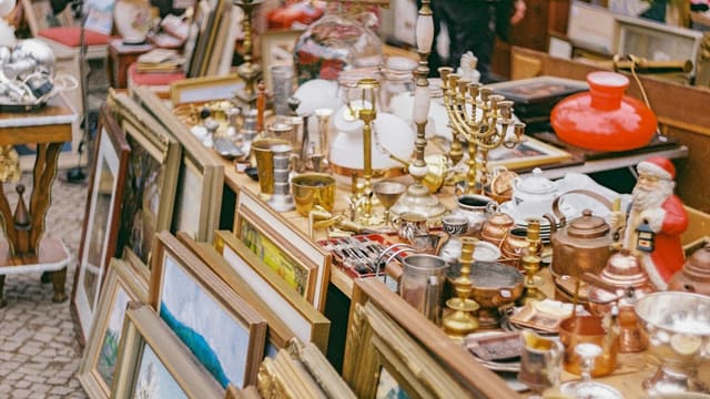 gold and silver trophy on brown wooden shelf