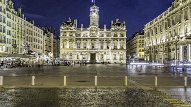 a large building with a fountain in front of it